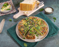 Frittata primavera au Grana Padano AOP, pommes de terre, petits pois et épinards