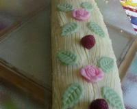Gâteau roulé à la pistache, intérieur au mascarpone et lemon curd, framboises, ganache au chocolat blanc.
