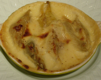 Des pâtes en forme de gros coquillage, fourrées d'un pesto de coeur d'artichaut rangées dans un plat nappées d'une sauce béchamel légère et passées au four.