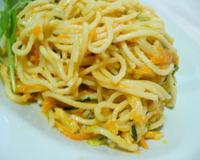 Des spaghettis accompagnées de légumes sautés, le tout enrobé d'une crème aux œufs et aux fromages.