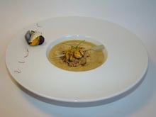 Ravioles de roquefort Papillon, sur un velouté de moules de Bouchot, crumble noisettes et grué de cacao